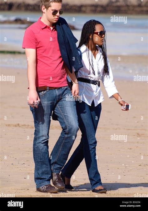 20s Mixed Race Couple Walking Along The Beach Stock Photo Alamy
