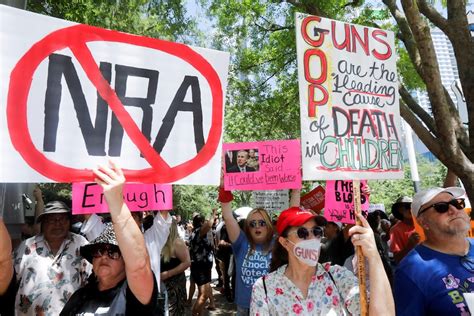 Protesters Holding Photos Of Shooting Victims Gather Outside Nra