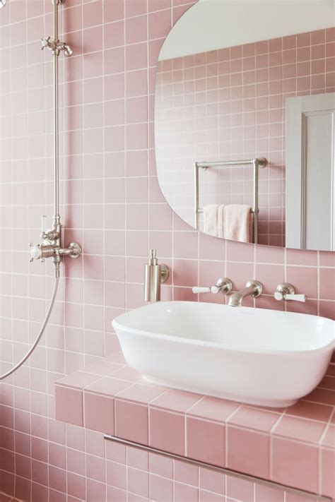 Simply by choosing pink tiles instead of white ones, this small bathroom becomes filled with endless personality. Tour 2LG's Pink Bathroom - Pink Bathroom Tiles