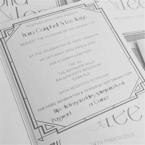 The Wedding Stationery Is Laid Out On Top Of Each Other