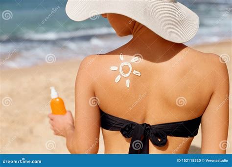 Beautiful Woman In Bikini Applying Sun Cream On Tanned Shoulder Sun Protection Stock Photo