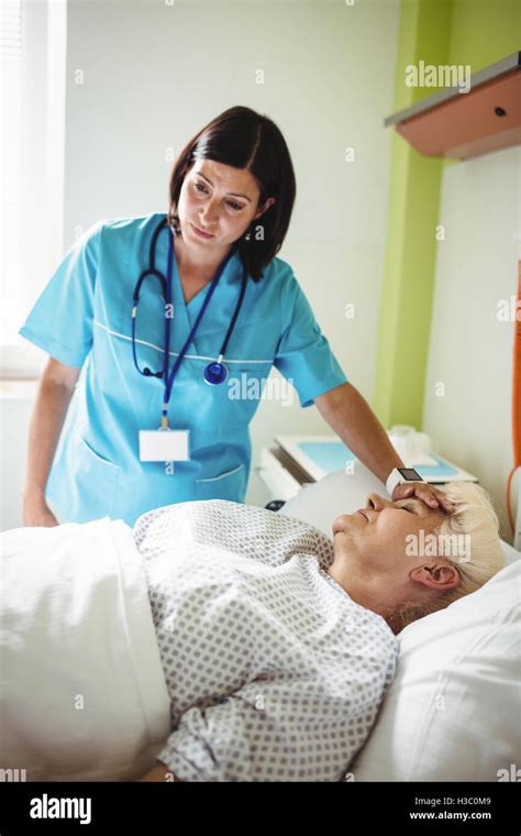 Nurse Checking Senior Patient Stock Photo Alamy