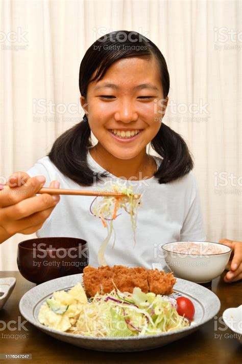 Japanese Girl Enjoys Having Dinner Stock Photo Download Image Now