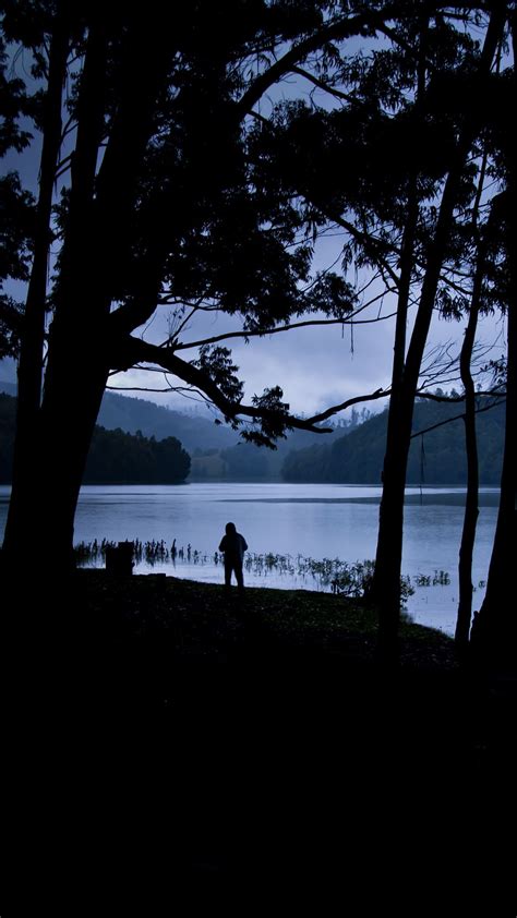 Download Wallpaper 938x1668 Man Silhouette Trees Lake Solitude