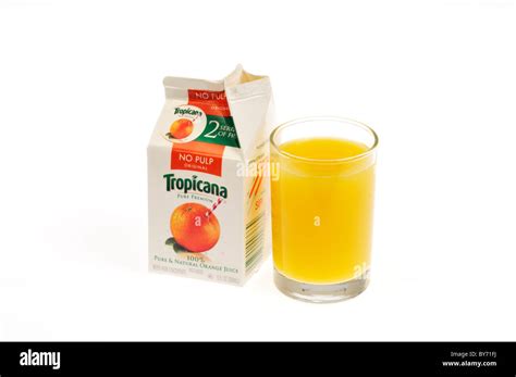 Poured Glass Of Tropicana Orange Juice With Open Carton On White