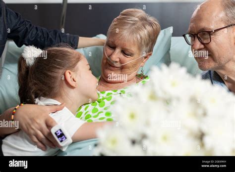 Little Granddaughter Bringing Flowers While Visiting Sick Grandmother