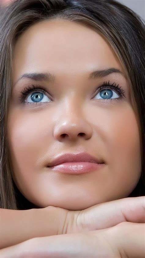 A Woman With Blue Eyes Is Posing For The Camera