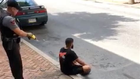 video shows police officer firing stun gun at unarmed man sitting on curb the new york times