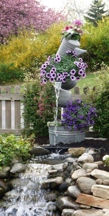 Tipsy Galvanized Buckets And Watercan Used As A Water Feature Garden