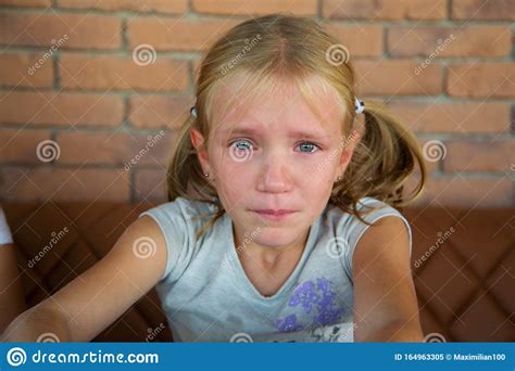 Blond Crying Teen Girl With Long Hair And Blue Eye Stock