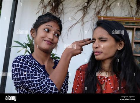 Indian Female Friends Talking And Fooling Around Near An Old House