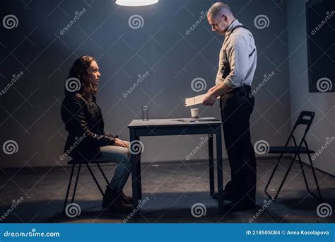A White Male Police Detective Talks To A Suspect In A Drug Trafficking