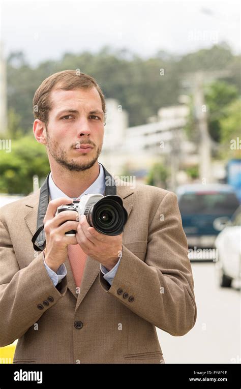 Successful Attractive Male Photographer Wearing Brown Suit Working
