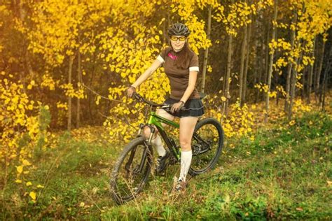 Woman Biking In Yellow Autumn Forest On A Meadow Stock Image Everypixel