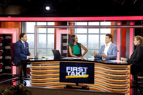 Three People Are Sitting At A Table On The Set Of First Take With Two