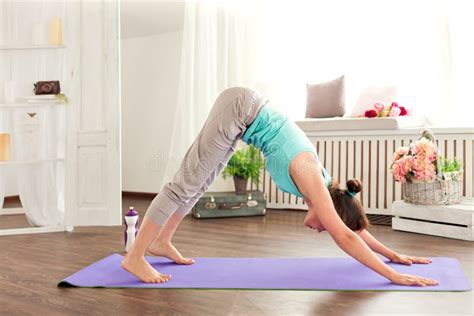 Young Caucasian Woman Staying In A Pose On The Mat Downward Dog Yoga
