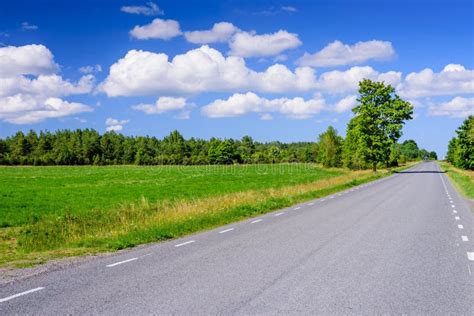 Asphalt Road On The Background Of Blue Sky With Clouds Stock Image
