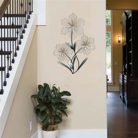 From lush greenery to displaying a collection of artwork, see these easy ways to decorate a blank wall. Stratton Home Decor Stratton Home Decor Tri-Flower Wall ...