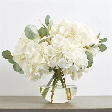 large white hydrangea and eucalyptus arrangement in rounded glass vase flower vase arrangements