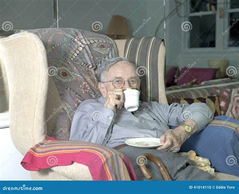 Senior Man Sitting On Couch With Cup Drinking Stock Photo Image Of