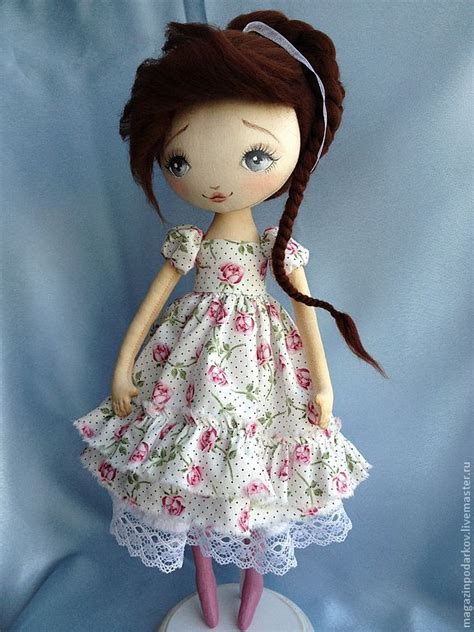 The Doll Is Wearing A Dress With Flowers On It