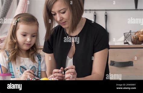 A Mother Checks How Her Daughter Paints She Tells Her What To Do In
