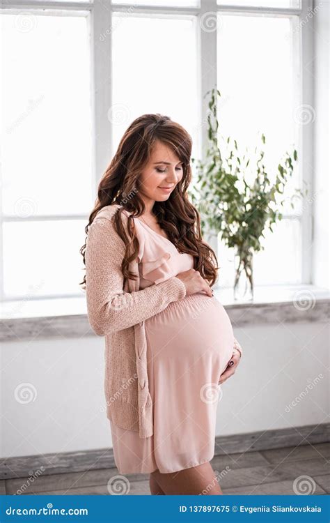 beautiful smiling pregnant woman is holding belly stock image image of dress abdomen 137897675