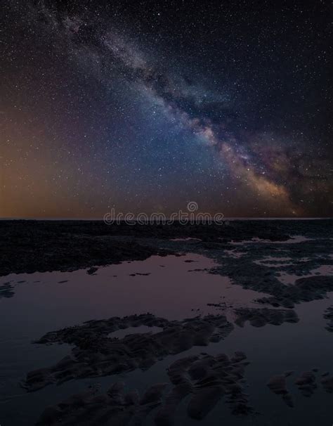 Vibrant Milky Way Composite Image Over Landscape Of Low Tide On Stock