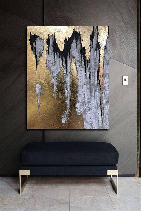A Black And Gold Painting On A Wall Next To A Bench In Front Of A Door