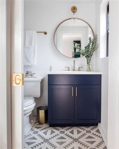 Transitional Powder Room Features Sophisticated Fittings Such As A Navy