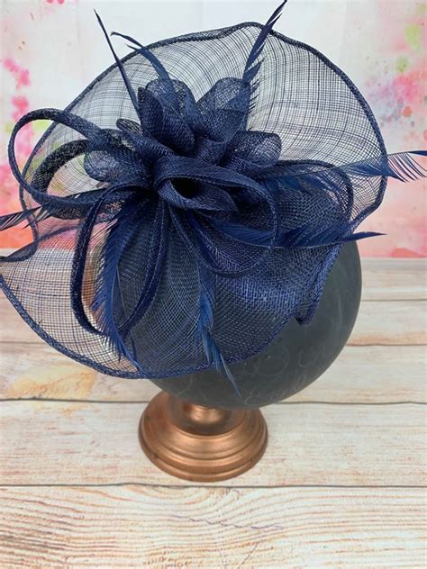 The most common wedding guest headpiece material is metal. Elegance Large Navy Sinamay Headpiece Fascinator RRP £65 ...