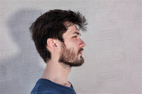 Head And Shoulder Side View Portrait Of Young Man With Beard Stock