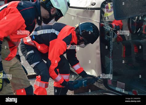 Firefighters Rescuing A Victim In A Car Accident Stock Photo Alamy
