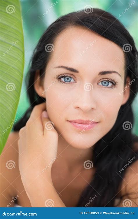 Beautiful Nude Brunette Smiling At Camera With Green Leaf