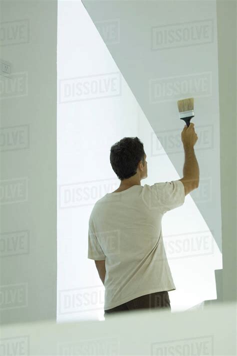 Man Painting Wall With Paintbrush Stock Photo Dissolve
