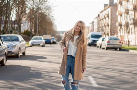 Amazing Blonde Girl Walking Alone On The Road In Old European City