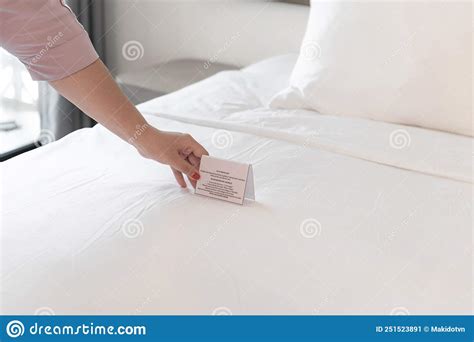 Woman Hands Putting A Card On The Bed She Wants To Change Bed Sheets