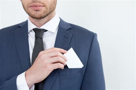Free Photo Serious Man Putting Business Card Into Pocket