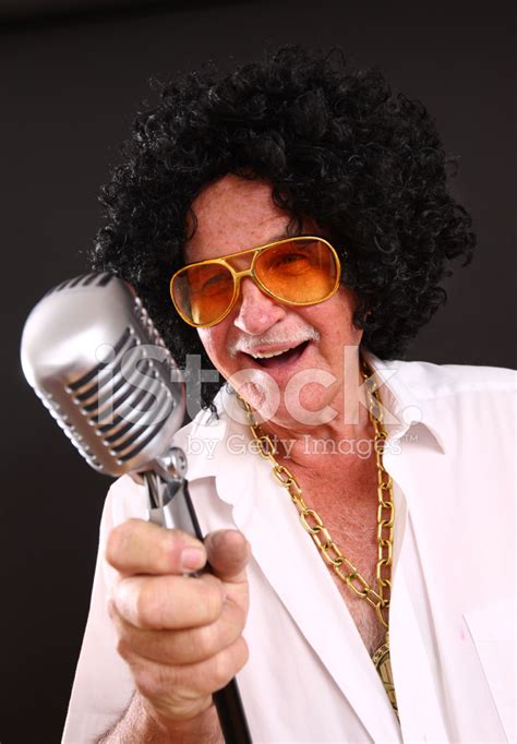 Senior Man In Costume Singing Into Microphone Stock Photos