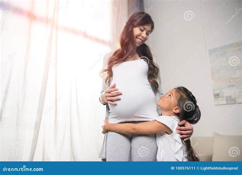 Girl Hugging Pregnant Mother Stock Image Image Of Motherhood Cute 100576111