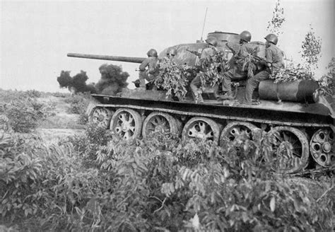 North Vietnamese Soldiers In Desant Riding A Tank Into Battle North