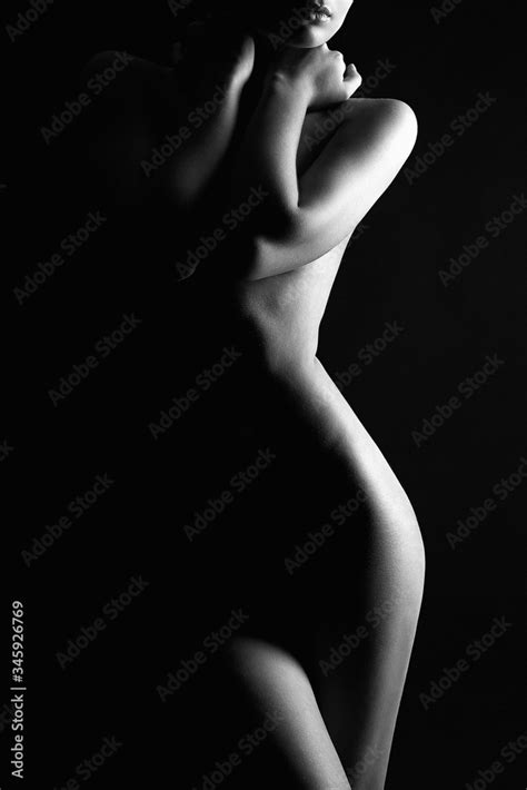 Nude Woman Silhouette Under Light In The Dark Stock Photo Adobe Stock