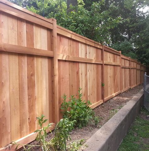 Installing a bamboo friendly fence on a chain link fence. Wood Fence