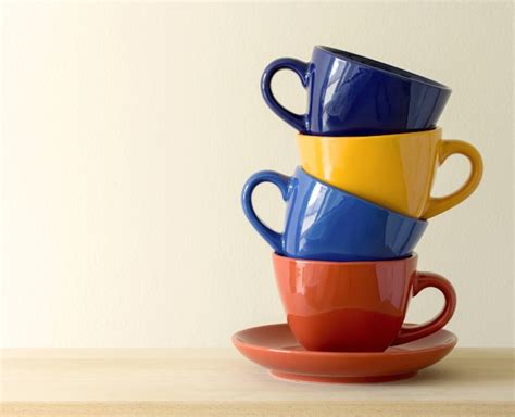 Free Photo Stack Of Colorful Coffee Cups On Table