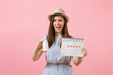 Portrait Of Sad Woman In Blue Dress Holding White Bottle With Pills