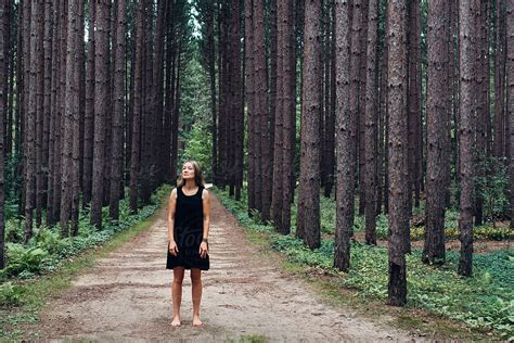 Woman In Black Dress On A Road In The Woods By Stocksy Contributor Gabi Bucataru Stocksy