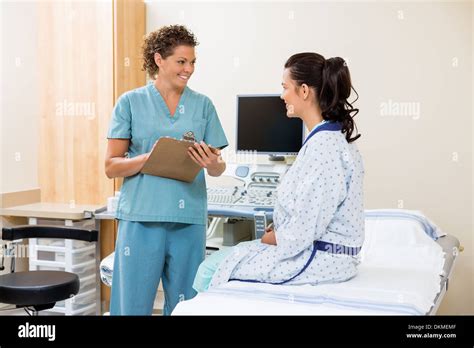 Nurse Looking At Patient Before Ultrasound Test Stock Photo Alamy