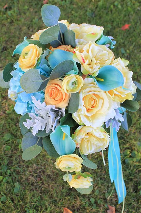I decided to go with blue and silver adding touches of metalique orange using fire bird wax. Thephoto: Dusty Blue And Yellow Wedding Flowers