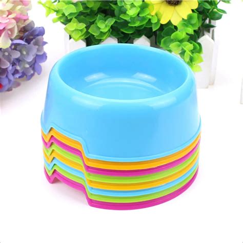 A Stack Of Colorful Bowls Sitting On Top Of A White Table Next To Some