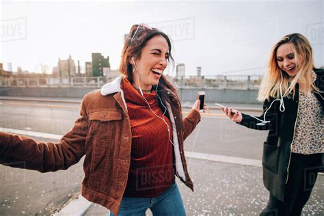 Friends Dancing In Street To Smartphone Music Milan Italy Stock